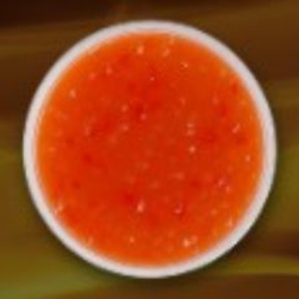 Smooth orange-red sauce in a white bowl
